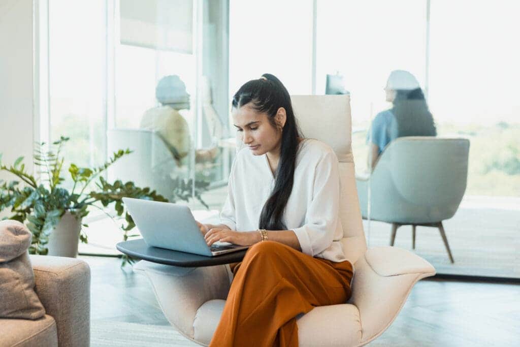 Businesswoman uses laptop in open concept office